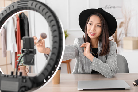 Female Asian beauty blogger recording video in studioの写真素材