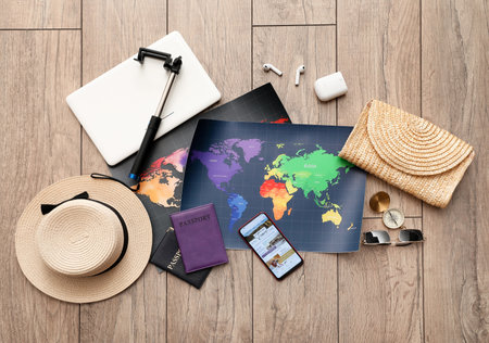 Phone and travel supplies on wooden background, top view. blogging concept