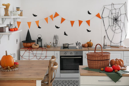 Interior of modern kitchen decorated for Halloween with pumpkins and countersの写真素材
