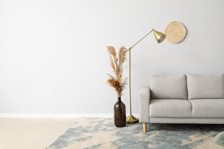 New sofa with modern lamp near light wallの写真素材
