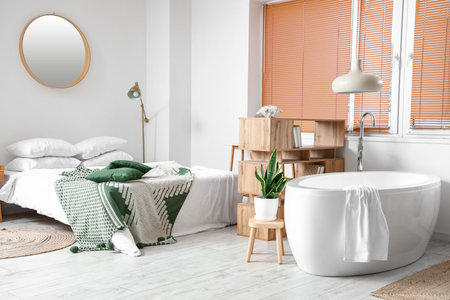 Interior of modern bedroom with bathtubの写真素材