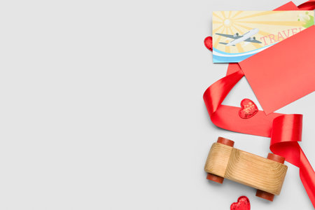 Envelope with gift voucher, wooden car, hearts and ribbon on light background. Valentine's Day celebrationの写真素材