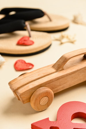 Wooden car on beige background, closeup. Valentine's Day celebrationの写真素材