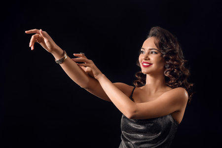 Elegant woman with trendy jewelry on dark backgroundの写真素材