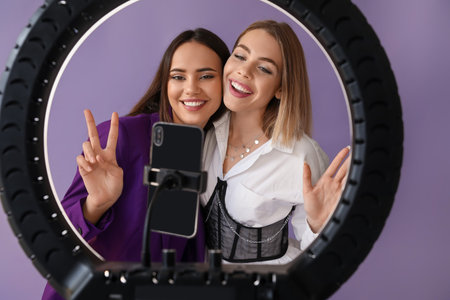 Young female bloggers recording video in studioの写真素材