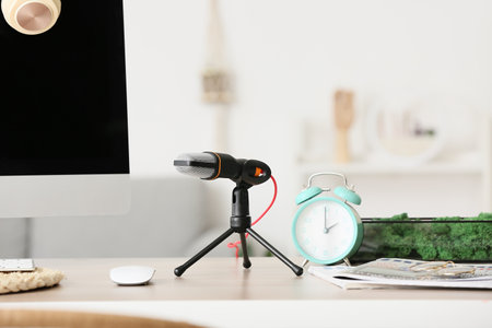 Modern microphone on table in room, closeupの写真素材