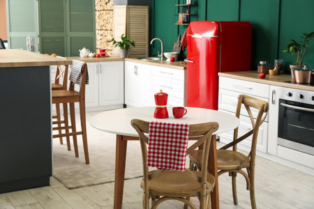 Interior of modern kitchen with dining table, stylish refrigerator and countersの写真素材