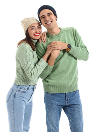 Happy young couple in warm sweaters on white backgroundの写真素材
