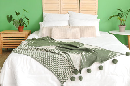Interior of modern bedroom with green wall
