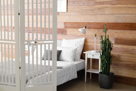 Interior of modern bedroom with wooden wallの写真素材
