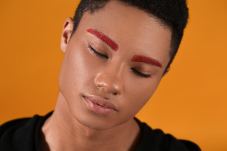 Fashionable young guy with unusual eyebrows on color background