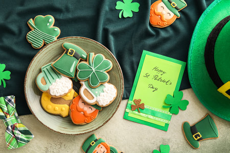 Composition with tasty gingerbread cookies for St. Patrick's Day celebration on color backgroundの写真素材