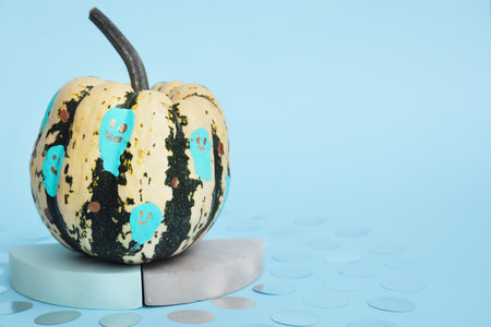 Painted Halloween pumpkin on color backgroundの写真素材