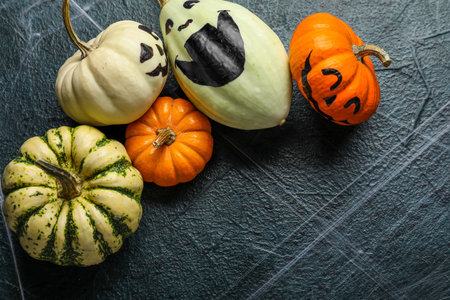 Different Halloween pumpkins on dark color backgroundの写真素材