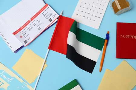 UAE flag with stationery, ticket, calendar and passport on blue backgroundの写真素材