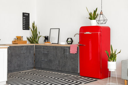 Interior of modern kitchen with counters and red fridgeの写真素材