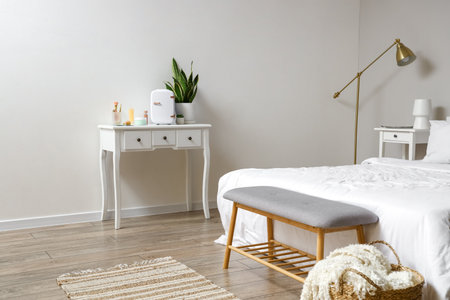 Small cosmetic refrigerator on table in bedroomの写真素材