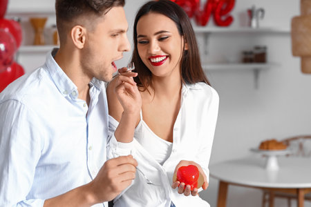 Beautiful young couple celebrating Valentine's Day at homeの写真素材