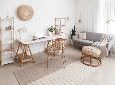 Stylish interior of room with modern workplace and comfortable sofaの写真素材