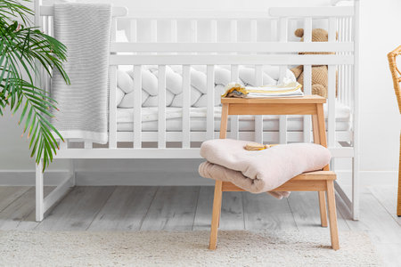 Baby clothes on stepladder stool in children's roomの写真素材