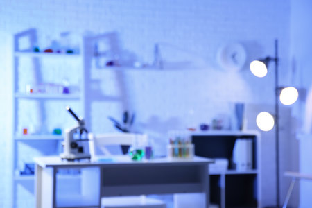 Chemical glassware and microscope on table in medical laboratoryの写真素材