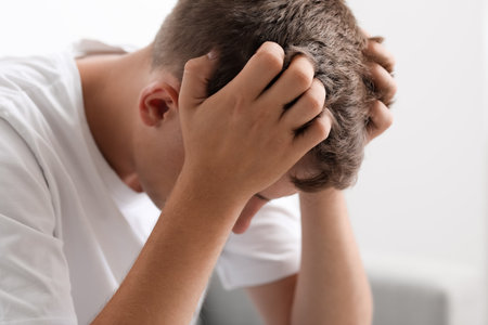 Stressed young man at home, closeupの写真素材