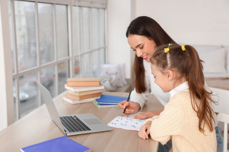 Cute girl studying with tutor at home