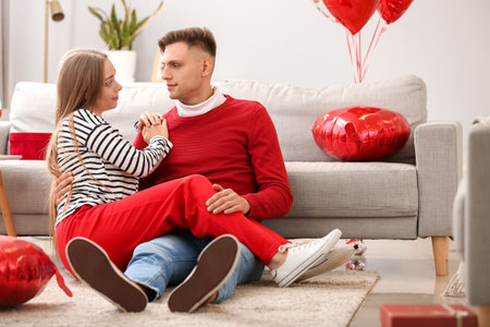 Happy couple spending time together at home. Valentine's Day celebrationの写真素材