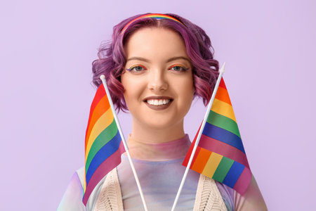 Young woman with LGBT flags on color backgroundの写真素材