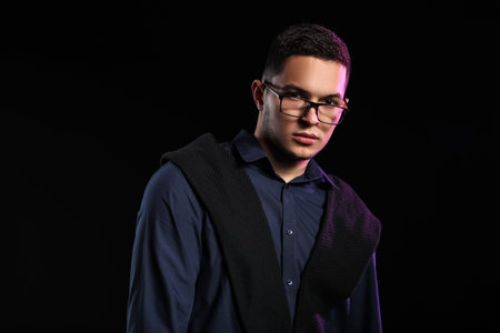 Portrait of handsome young man on black backgroundの写真素材