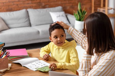 Little African-American boy studying Mathematics with tutor at homeの写真素材