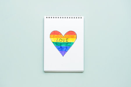 Notebook with rainbow heart on light background. LGBT conceptの写真素材