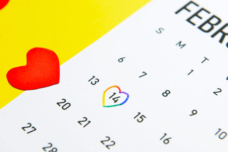 Calendar with marked date of Valentines Day on color background, closeup. LGBT conceptの写真素材