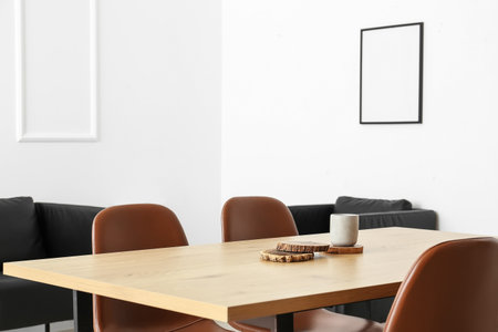 Dining table with wooden holders and candles in light room