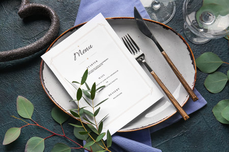 Beautiful table setting for wedding with menu on black backgroundの写真素材