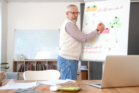 Mature teacher conducting Math lesson online at home