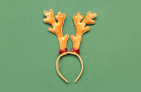 Christmas reindeer horns on green backgroundの写真素材