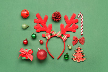 Christmas reindeer horns with gift and decor on green backgroundの写真素材