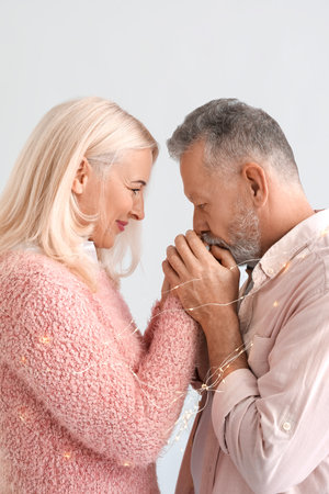 Portrait of happy mature couple on light backgroundの写真素材