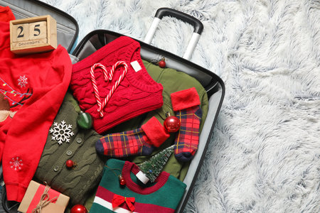 Open suitcase on light fluffy background. christmas holidays conceptの写真素材