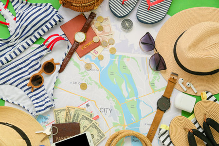 Beach accessories with city map on color background