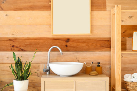 Interior of stylish bathroom with drawers, sink and mirrorの写真素材