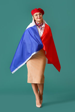 Beautiful woman with flag of France on green backgroundの写真素材
