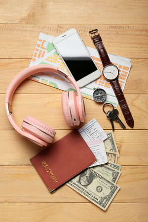 Guide's belongings with headphones and mobile phone on wooden backgroundの写真素材