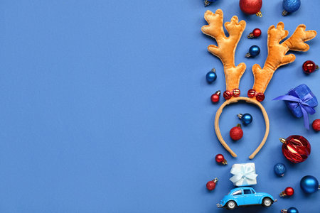 Christmas reindeer horns and decorations on blue backgroundの写真素材