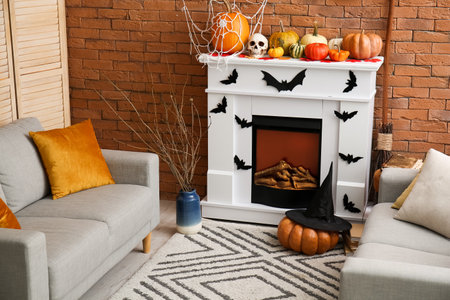 Interior of living room decorated for Halloween with fireplace and sofasの写真素材