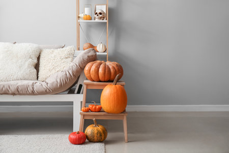 Stepladder with Halloween pumpkins and couch in living roomの写真素材