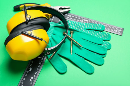 Hearing protectors with builder's tools on green backgroundの写真素材