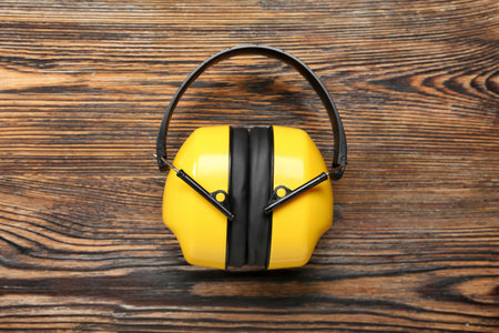 Hearing protectors on dark wooden backgroundの写真素材