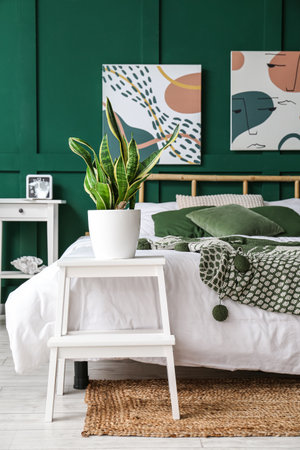 Step stool with houseplant in interior of stylish bedroom